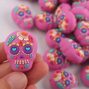 Dettaglio di perla a teschio in silicone rosa con motivi floreali colorati in rilievo 3D