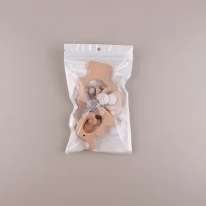 Detail of baby beechwood bear teething ring and crochet beads in eco-friendly packaging