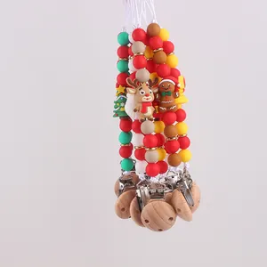 Detail of food-grade silicone pacifier clips with 3D reindeer and gingerbread man designs