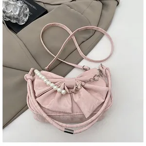 Pink bow handbag featuring large pearls and silver metal chain details for women