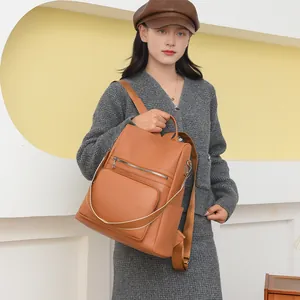 Brown faux leather backpack with litchi texture and silver zipper for women