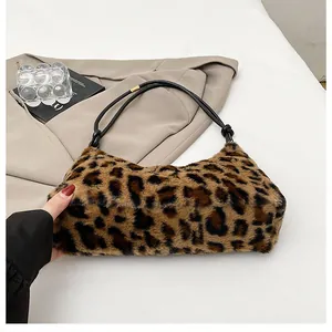Detail of leopard print plush shoulder bag with minimalist black cord strap design