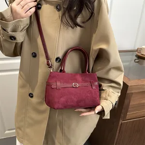 Vintage burgundy suede bucket bag with leather strap and gold buckle for women