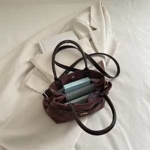 Retro frosted dark brown bucket bag showing spacious interior with leather strap
