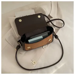 Detail view of the cat-themed crossbody bag showing interior space and metal magnetic snaps
