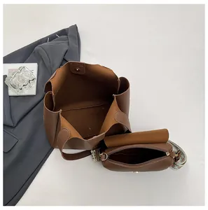 Deep brown leather tote set with wide geometric patterned strap and large capacity