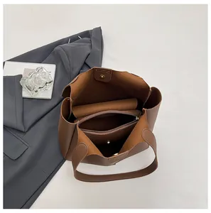 Top view showing the internal compartments and magnetic closure of the brown tote bag