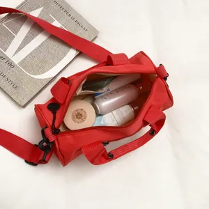 Red cylindrical travel bag with skincare items shown from a top-down perspective