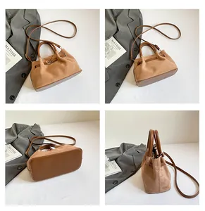 Detailed views of khaki suede handbag showing base construction and side profile