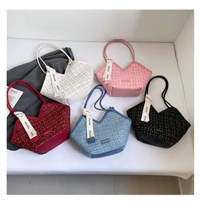Flat lay of five tweed tote bags in white pink burgundy blue and black with V-cut detail