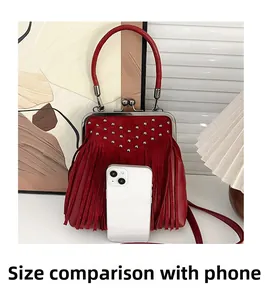 Detailed comparison of the red vintage tassel shell bag size next to a smartphone