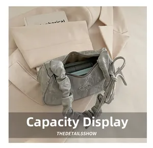Detail view of the pleated handbag interior showing capacity and zipper closure