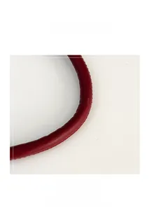 Detailed close-up of dark red leather handbag handle with fine stitching and soft texture