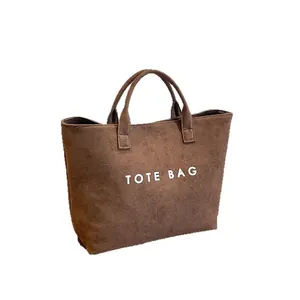 Minimalist large brown suede tote bag with Tote Bag text and dual handles