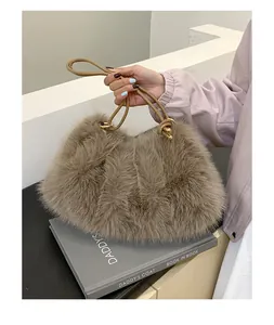 Detailansicht der khakifarbenen Webpelz-Tasche mit Plüschstruktur und goldenen Knoten