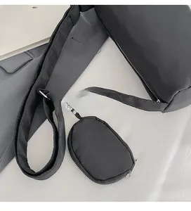 Detail of black nylon crossbody bag with adjustable wide strap and small coin purse
