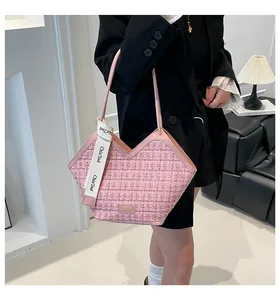 Detail of pink tweed woven tote bag with a V-shaped opening and stylish brand strap