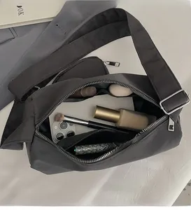 Detail view of the spacious interior of a black nylon crossbody bag with pockets