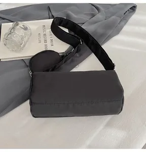 Detail of black nylon crossbody bag with wide strap and matching round coin purse