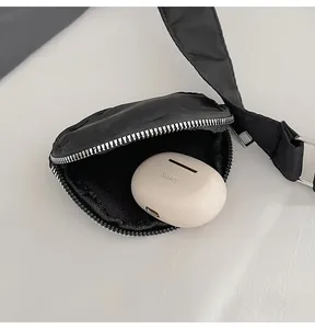Detailed view of black quilted nylon mini storage bag with silver zipper for earphones