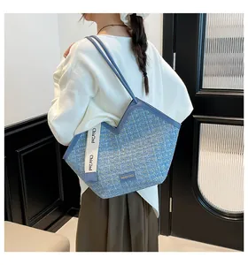 Detail of blue tweed tote bag with V-shaped opening and leather straps on model