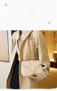 Close-up of cream quilted crossbody bag with golden square lock and metal accents