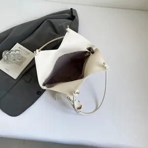 White geometric leather tote bag with branded canvas strap and woven structure design
