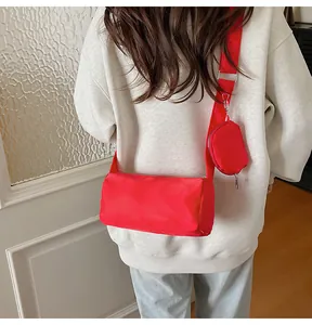 Detail of red nylon toast bag with matching round mini pouch and wide strap