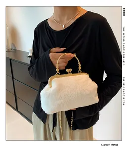 Detail of white faux fur handbag featuring ornate gold metal handle and chain strap