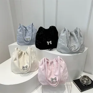 Pleated tote bags in five colors with silver butterfly charms on white display