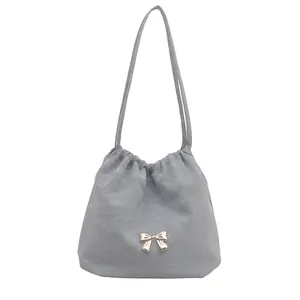 Light blue butterfly shoulder bag with pleated fabric texture and elegant chain straps