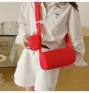 Detail of red cylinder shoulder bag with a matching small round coin purse attachment