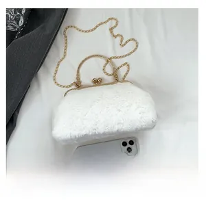 White faux fur handbag detail with gold handle and smartphone for size comparison