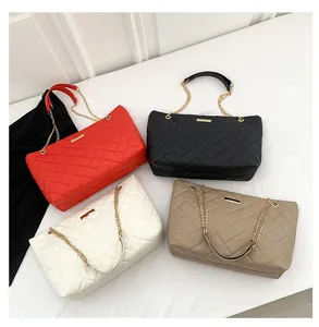Quilted tote bags set in red, black, white, and apricot with gold chain straps