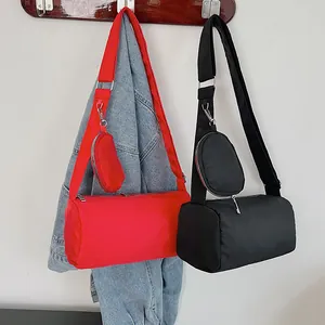 Red and black nylon barrel crossbody bags with wide straps and round coin purses