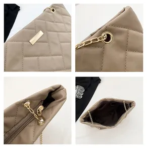 Detail view of beige quilted tote featuring gold chain straps and inner lining pockets