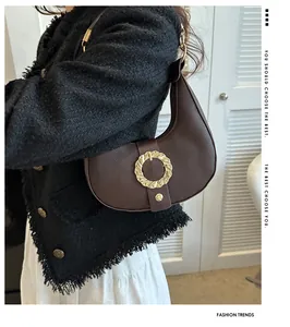 Dark brown grained leather half-moon bag with gold ring buckle worn with tweed jacket