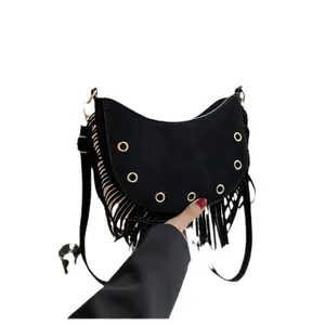 Fashionable black suede crescent bag with bohemian tassels and gold stud accents