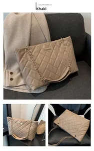 Detail view of khaki quilted tote bag with golden chain strap and woven texture