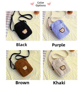 Detail showing various colors of corduroy crossbody bags with cute teddy bear patches