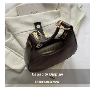 Top view of dark brown pebbled leather crescent bag showing internal storage capacity