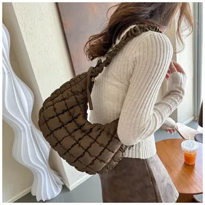Détail du sac bandoulière croissant matelassé marron avec une bandoulière plissée