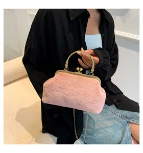 Pink faux fur handbag with gold handle and chain strap shown in a lifestyle setting