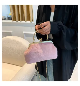 Detailed close-up of pink faux fur clutch with gold metal frame and beaded handle
