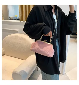 Detail of pink faux fur handbag featuring a vintage gold frame and elegant metal handle