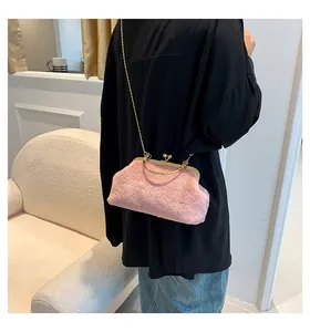 Pink faux fur bag with gold chain strap and ring handle shown in a lifestyle setting