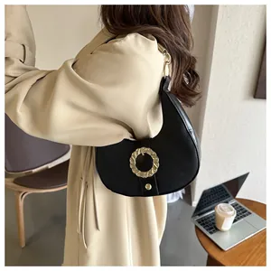 Chic black litchi leather crescent underarm bag with gold metal buckle detail