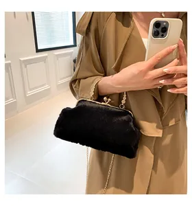 Detail of black faux fur handbag featuring gold hardware and elegant bead handle