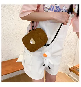 Brown corduroy crossbody bag with cute bear embroidery and a white duck plush pendant