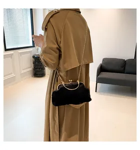 Elegant black faux fur frame bag with gold handle and chain strap for autumn winter